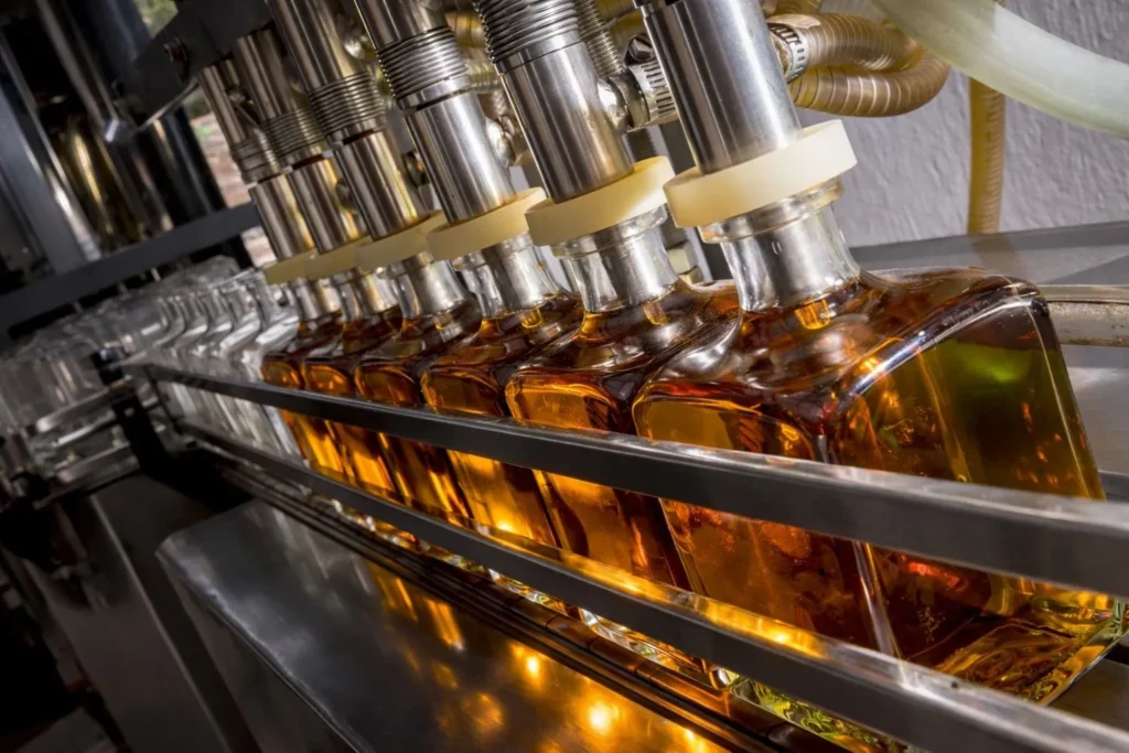 Alcohol and spirits bottling line for glass bottle filling, capping, and packaging