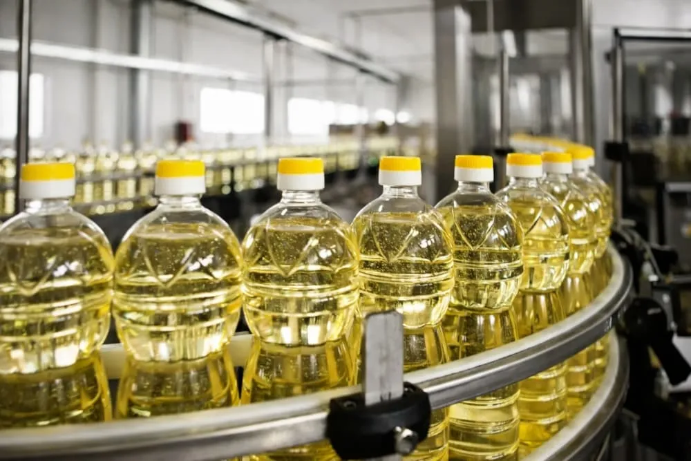 Edible oil bottling production scene with filling capping labeling and packing