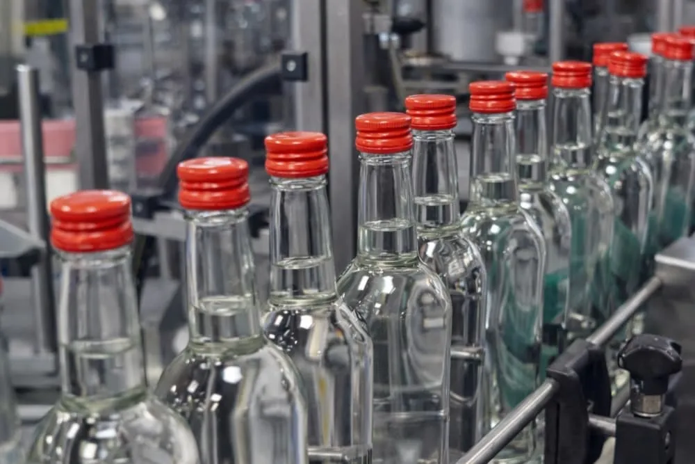 Liquor bottling line using FW Series ROPP capping machine for aluminum anti-theft caps
