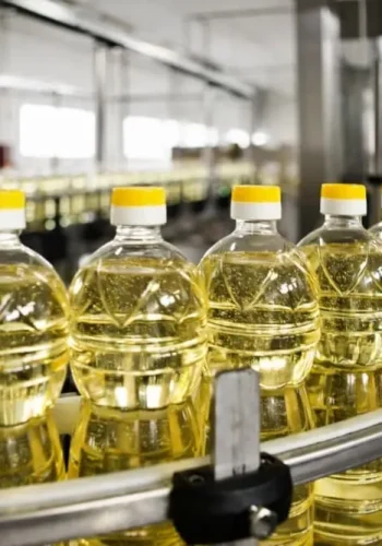 Edible oil bottling production scene with filling capping labeling and packing