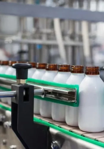 Oral liquid bottling scene with small bottle filling capping labeling and packing